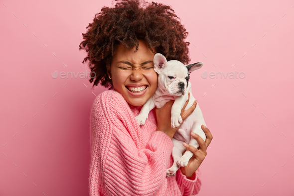Glad woman embraces small four legged friend, rejoices saving it during extremal situation on water