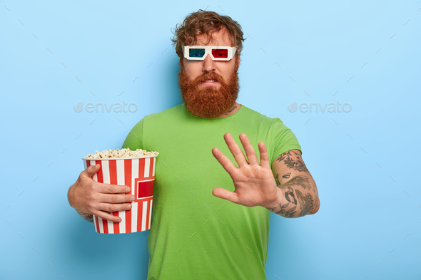 Displeased unhappy ginger guy in cinema refuses talk about film and characters after watching, makes