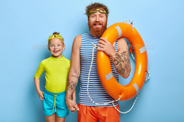 Happy friendly dad and daughter ready for swim, spend cool summer holidays together, wear goggles, h