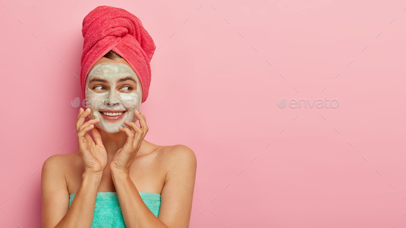 Beauty and health care concept. Gentle positive woman applies facial