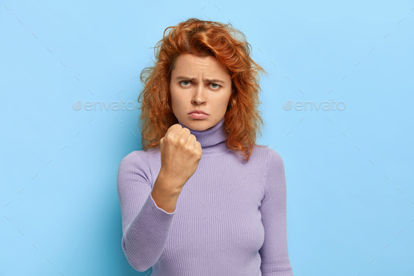 Fierce Displeased Serious Redhead Girl Shows Clenched Fist With Anger Being Ready For Any 8885