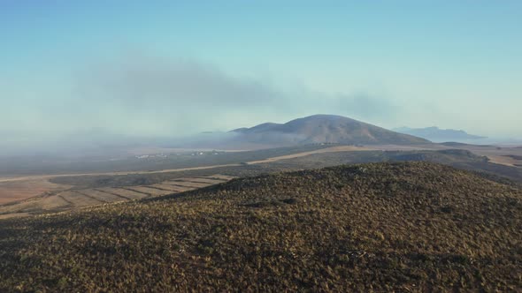 Aerial Shot with Clear Skies and Background and Lush Forest in Foreground alt