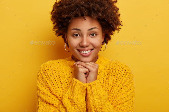 close-up-shot-of-romantic-pleasant-looking-woman-keeps-both-hands-under