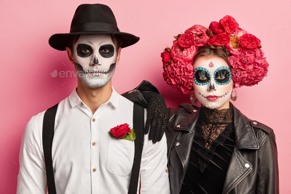 Horizontal shot of spooky couple dressed for Day of Dead in Mexico ...
