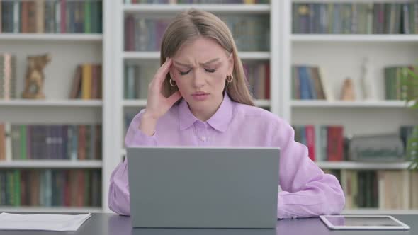 Woman Having Headache While Working on Laptop alt