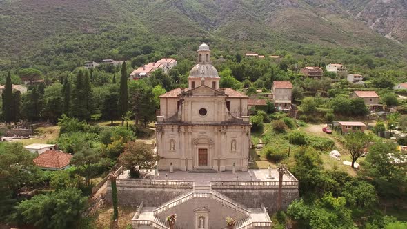 Drone View of the Stone Facade of the Church on the Banks of the Prcanj alt