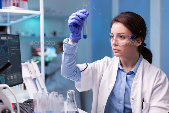 Scientist chemist analyzing a liquid sample and discovering genetic  infection with coronavirus Stock Photo by DC_Studio