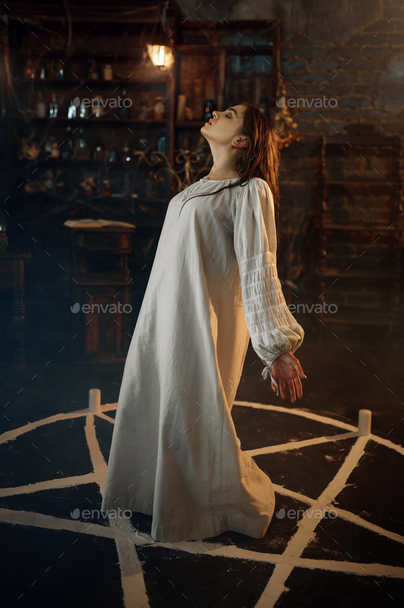 Creepy demonic woman standing in the magic circle