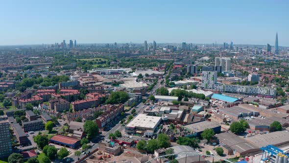 Dolly forward drone shot over South London on a sunny day alt