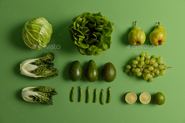 top view of ripe and organic grapes on green Stock Photo by