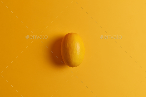 Oval edible yellow mango. Delicious exotic fruit. Sweet soft pleasant to eat product, provides your