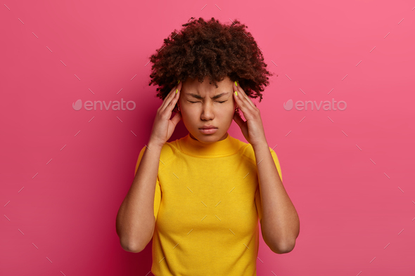 People, tiredness, medicine, symptom concept. Unhappy distressed ethnic woman has high blood pressur - Stock Photo - Images