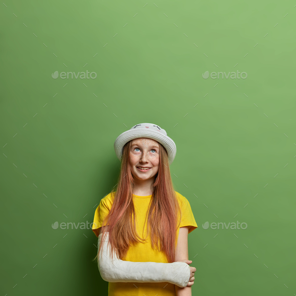 Cheerful long haired teenage girl with broken arm in plaster cast after reckless bicycle driving, we