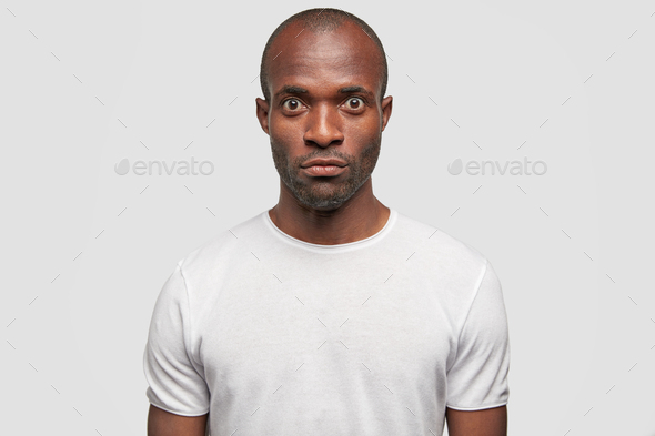 Photo Of Serious Dark Skinned Male With Surprised Expression Feels