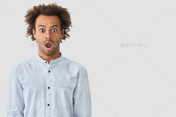 Studio shot of dark skinned mixed race young male being surprised to be accused of what he didn`t do