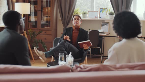 Black Couple Having Quarrel and Talking with Psychologist on Therapy Session alt