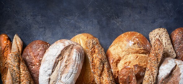 Banner with Different Types of Bread on dark surface. Close up. Bakery concept. - Stock Photo - Images