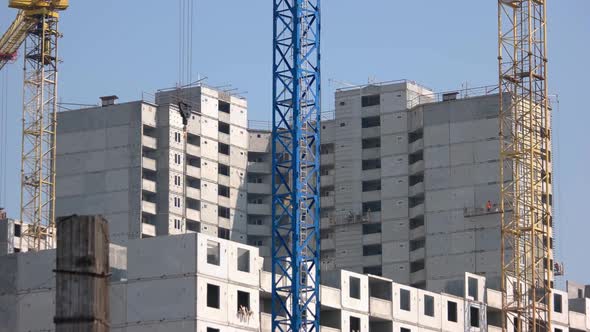Construction Buildings with Workers and Colored Cranes alt