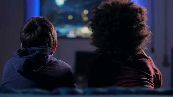 Rear View Teen Boys Fighting in Video Game at Home alt