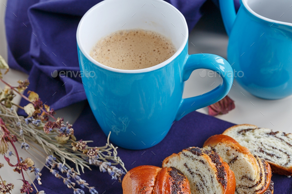 Sweet Bun with Poppy Seeds with a Cup of Coffee or Cappuccino