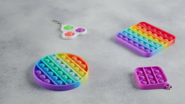 Multicolor Rainbow Silicone Poppit Fidget Toys with Bubbles Flat Lay on Table alt