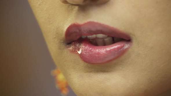 Close-up of young woman licking lips