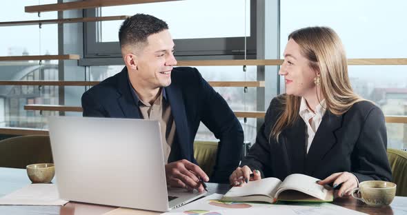 Man and a Woman Discussing Work in the Brightly Lit Modern Office. Concerned Male and Female Working alt