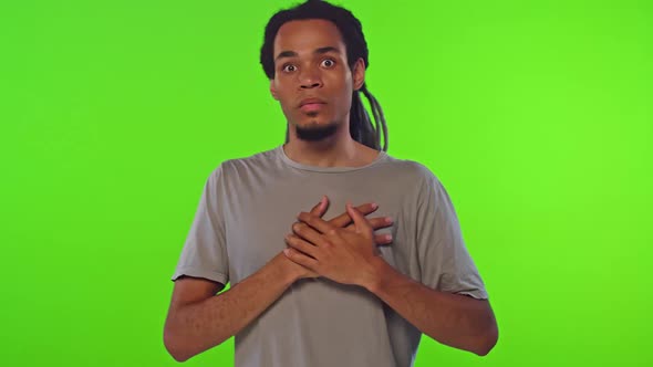 Young Scared African American Man Clutching Heart Feeling Stressed and Afraid alt