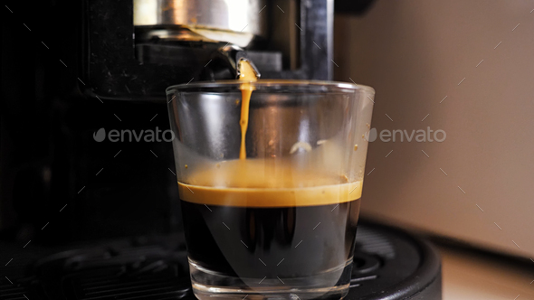 Espresso coffee in glass cup. Coffee pod machine.