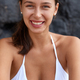 Glad woman with toothy smile, perfect breast, looks gladfully at camera,  dressed in swimsuit, models Stock Photo by wayhomestudioo