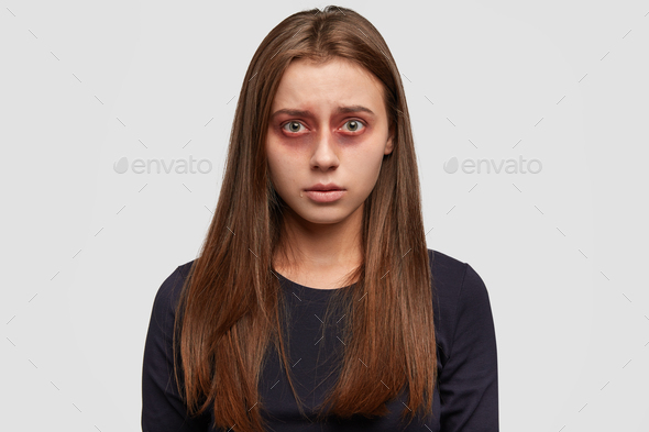 People, discrimination and humiliation concept. Sorrowful woman with bruises on face, has tears, cri - Stock Photo - Images