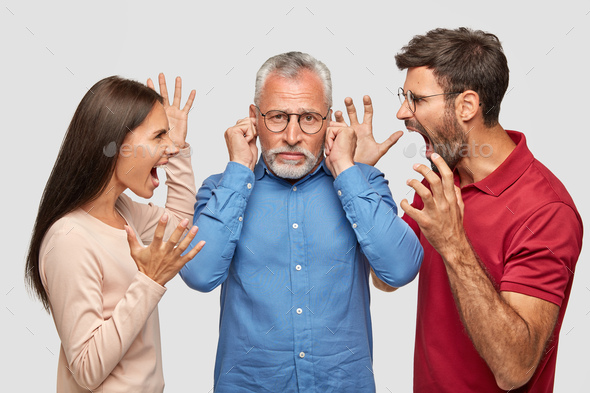 People, anger, madness concept. Furious brother and sister shout desperately at their mature father