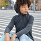 Vertical shot of thoughtful teenager dressed in stylish hoodie and