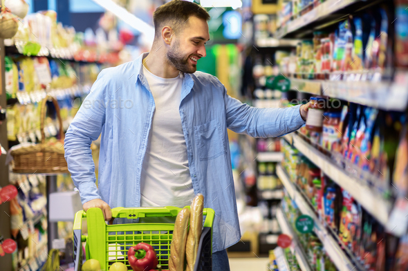 Portrait of man shopping in supermarket with trolley cart Stock Photo ...