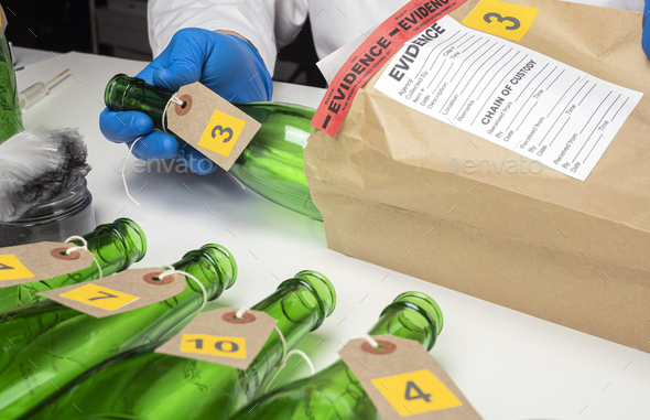 Police scientist removes bottle from evidence bag implicated in murder, conceptual image