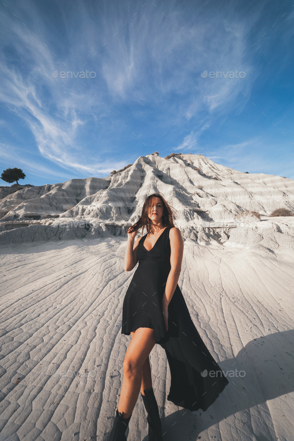 Standing Woman Wearing Black Dress And Black Boots Stock Photo