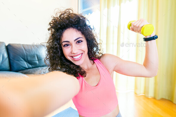 Sporty Woman In Sportswear Is Sitting On The Floor With Dumbbells Using Taking A Selfie Stock 