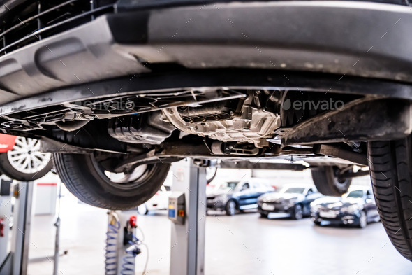 Close up of chassis or wheels or motor on lift on Service station - Stock Photo - Images