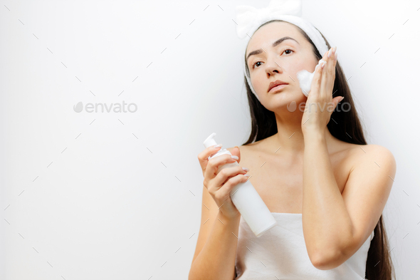 woman applying Facial Cleanser