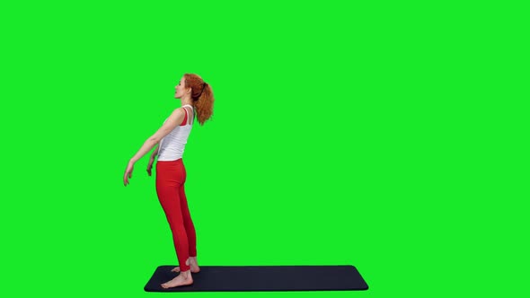 Fit Sporty Woman Standing In Yoga Bridge Pose On Mat Against Green Screen
