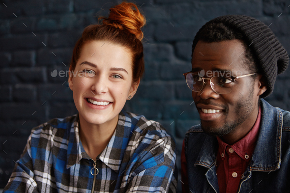 People, friendship and relationships. Portrait of interracial young couple of happy redhead Caucasia