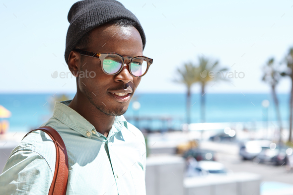 Attractive black European tourist with knapsack posing outdoors while exploring sights and locations - Stock Photo - Images