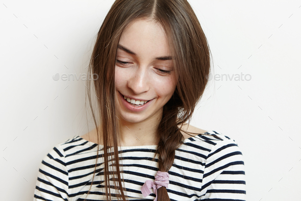 Pretty Girl With Messy Hair Braid Looking Down With Cute Shy Smile Showing Her Perfect White
