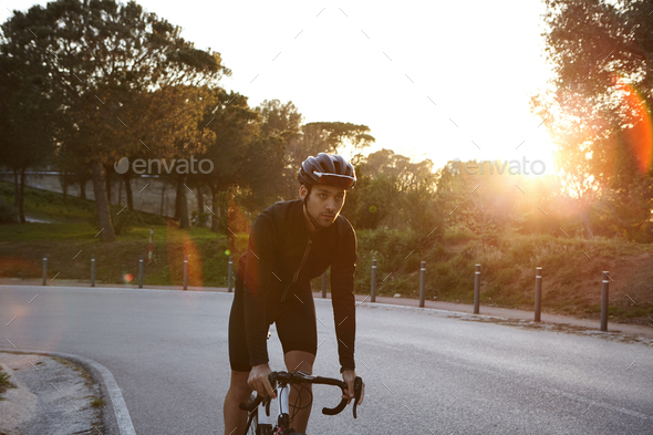 People, sports, endurance, extreme and active lifestyle Handsome self-determined male cycli Stock Photo wayhomestudioo