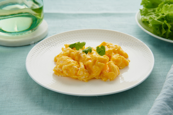 Scrambled eggs, omelette. Breakfast with pan-fried eggs. Texture of omelet on white plate - Stock Photo - Images