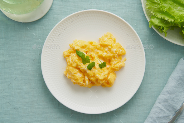 Scrambled eggs, omelette. Breakfast with pan-fried eggs. Texture of omelet on white plate - Stock Photo - Images