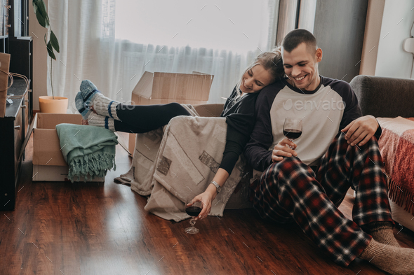 Moving Day, new home, Valentine's Day, unpacking boxes, newlyweds concept. Couple Celebrating - Stock Photo - Images