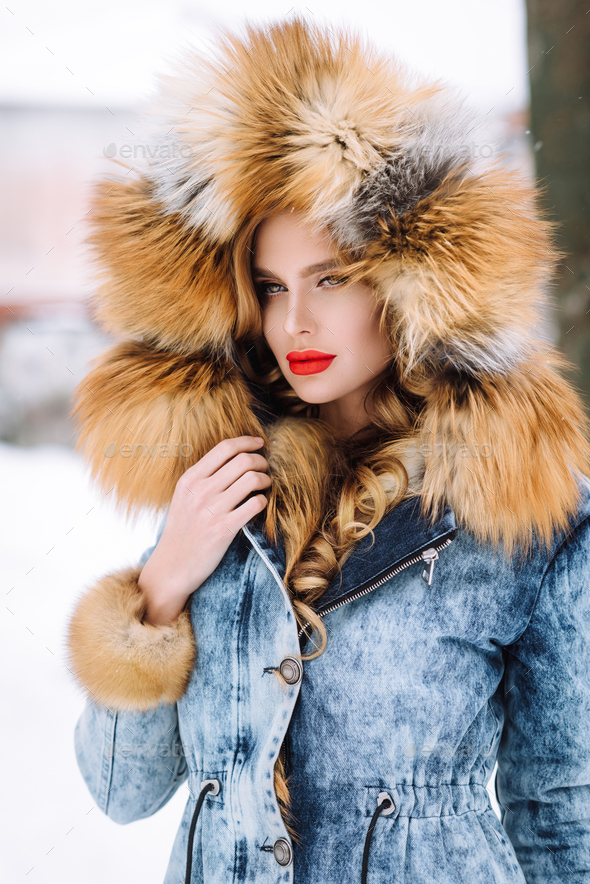 beautiful blonde girl posing in winter fur coat in the snow Stock Photo ...