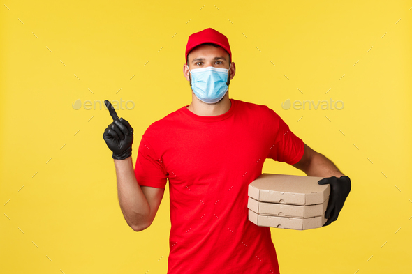 Food delivery, tracking orders, covid-19 and self-quarantine concept. Courier in red uniform and