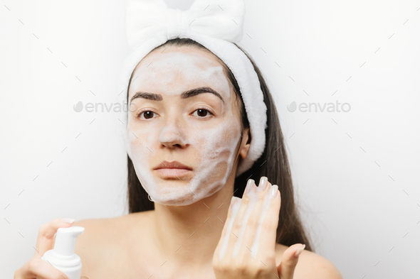 woman applying Facial Cleanser